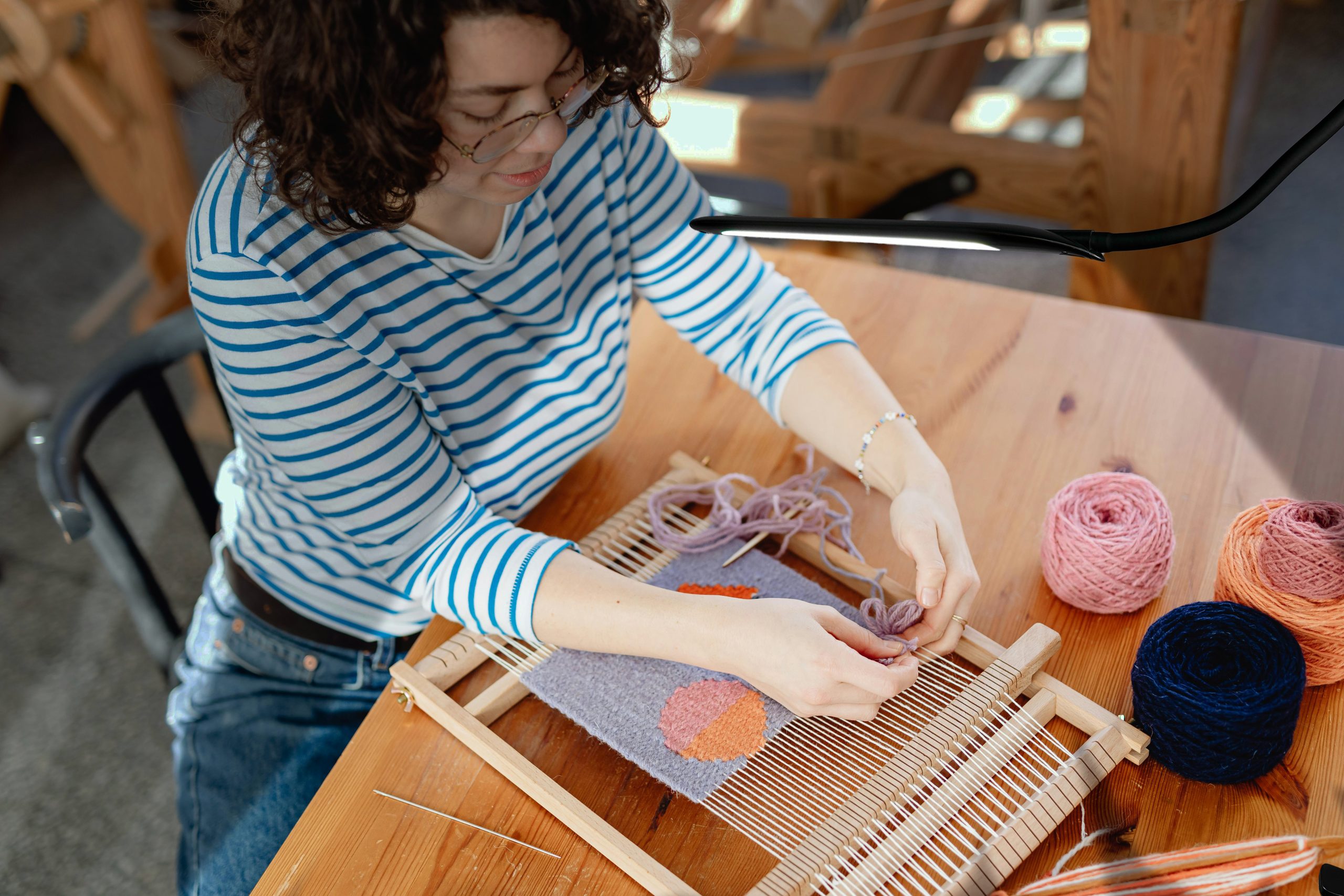 Lady doing crochet with light